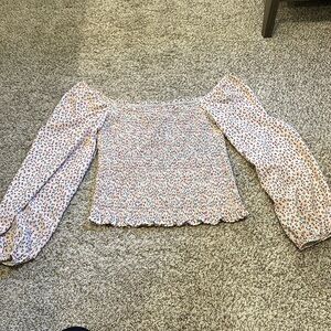 Smocked floral long bubble sleeve. Can be worn on or off the shoulder.